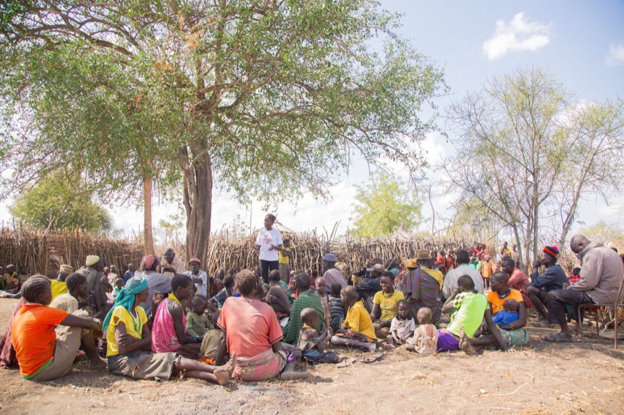 A community gathered together under a tree